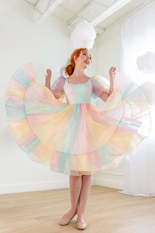 Novella Dress Deluxe shown mid-twirl with puffed sleeves and layered skirt
