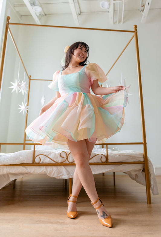 Princess Puff dress shown mid-twirl in soft pastel shades near bedroom window
