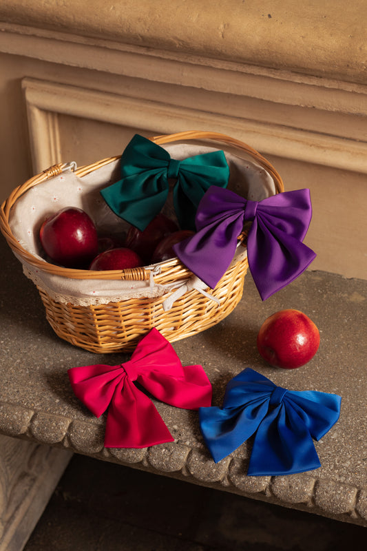 Basket of Gemstone Collection hair bows in tourmaline teal, ruby red, sapphire blue, and amethyst purple