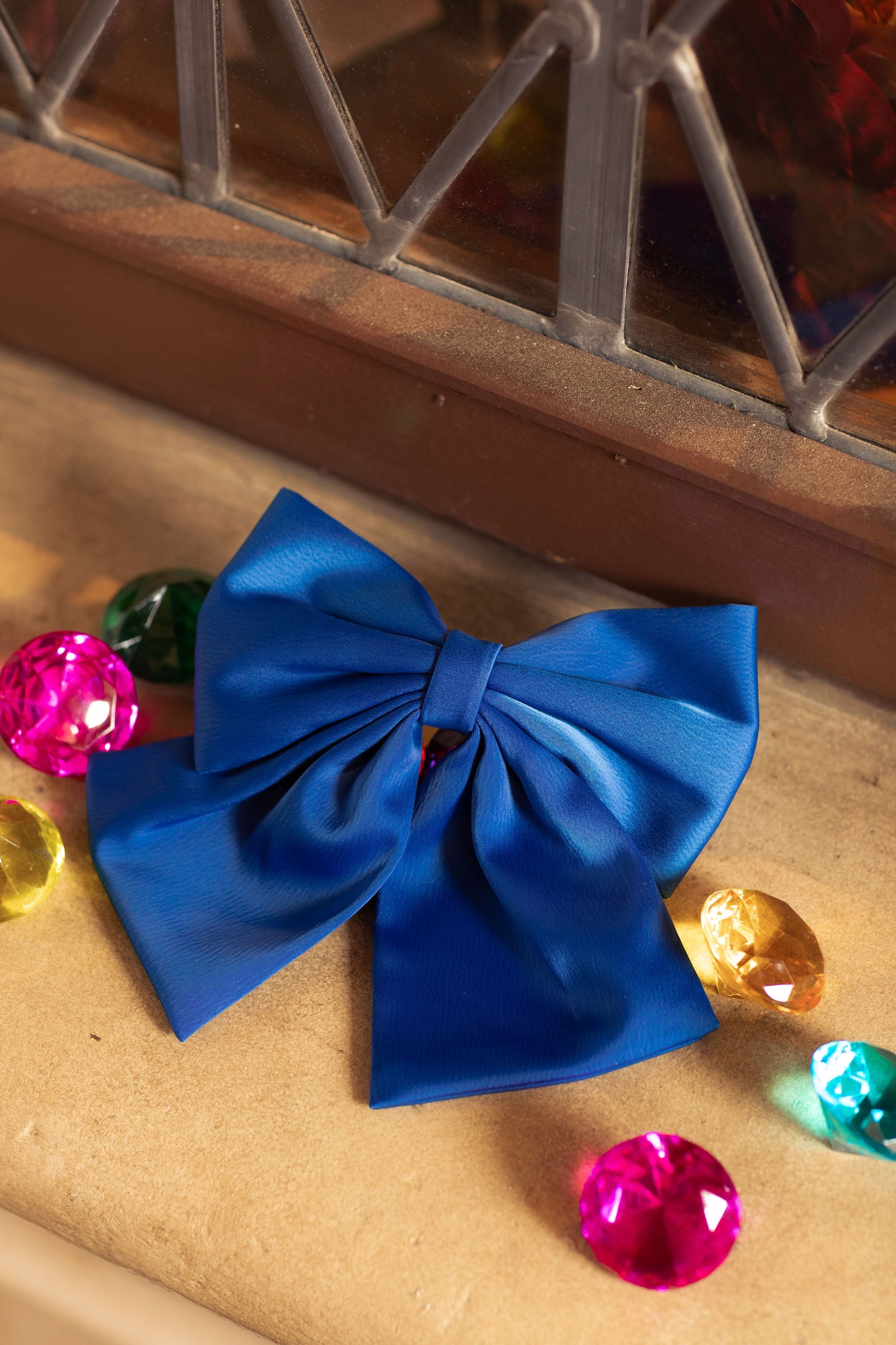 Sapphire blue hair bow from the gemstone collection styled with ruby red apples