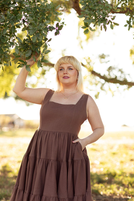 Close-up of The Madonna Dress in Nutmeg Brown featuring hidden pockets and a square neckline.