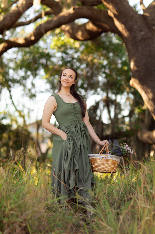 Woman holding a basket wearing The Thyme Dress in the Cottagecore Collection