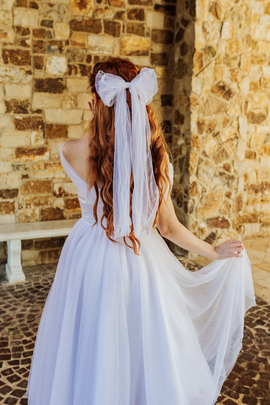 Close-up of white double tail bridal bow with long flowing ribbons